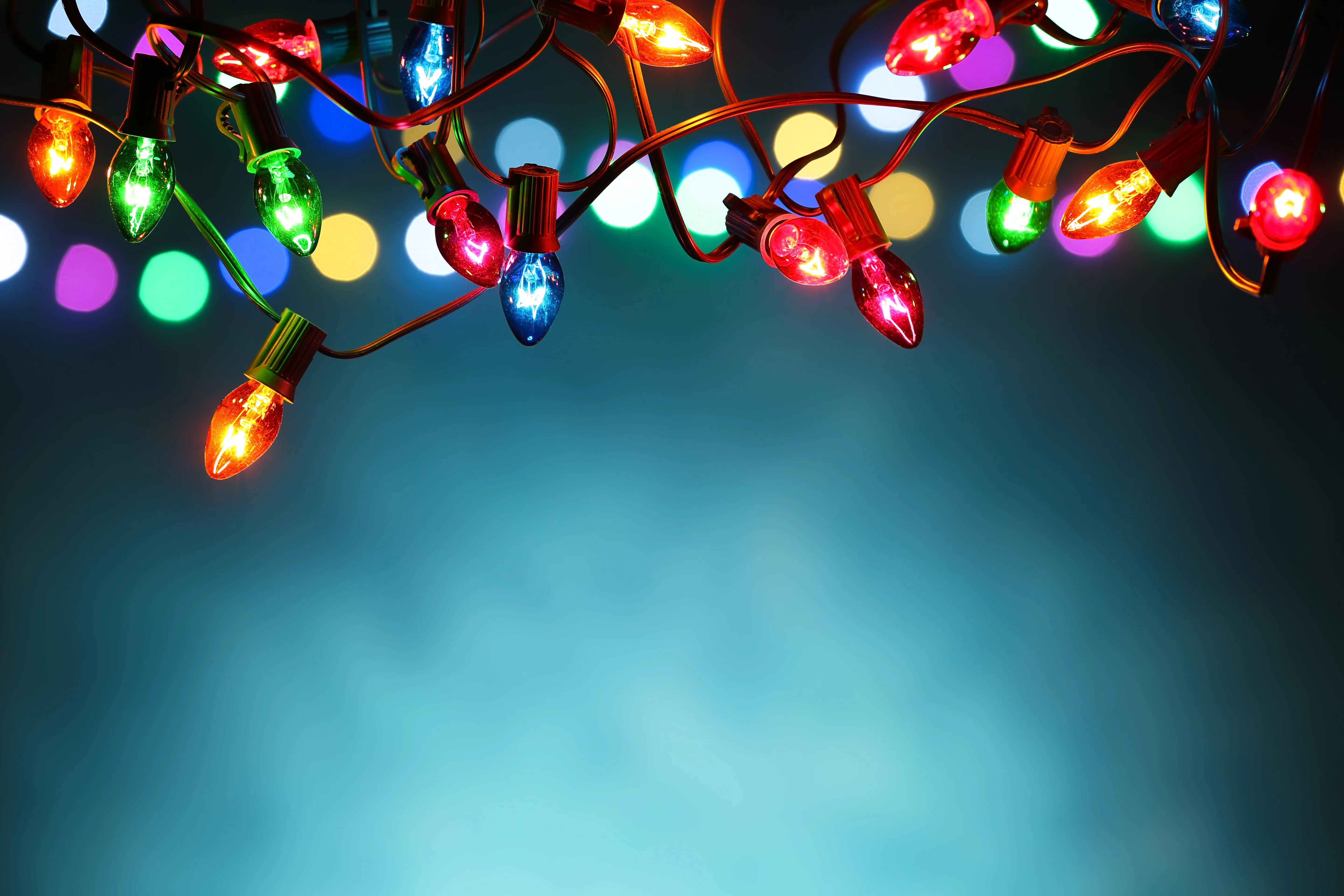 Cartoon Christmas lights against blue background