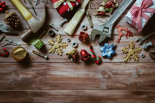 Photo of tools and Christmas ornaments on a wooden table