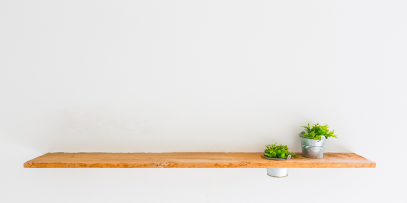 Floating wall shelf with potted plants on it