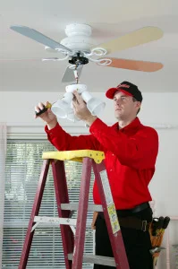 Mr. Handyman technician installing a ceiling fan