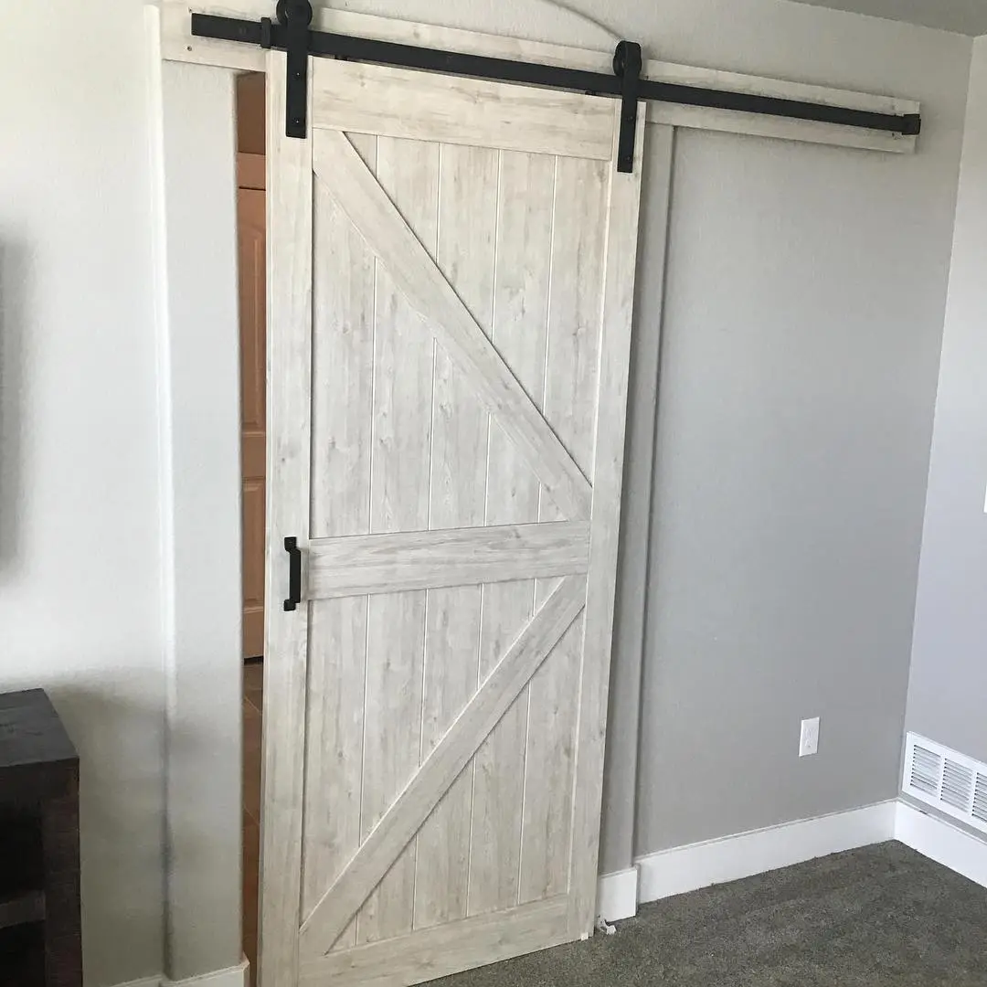 A sliding, barn-style door after it has been installed in the interior of a home by Mr. Handyman.