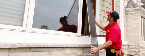 Mr. Handyman technician installing window.
