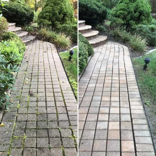 A stone walkway before and after it has been cleaned with pressure washing service from Mr. Handyman in Western Main Line