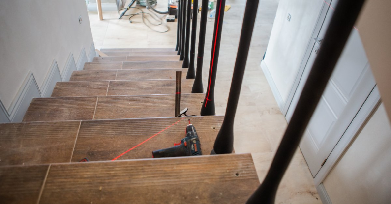 A basement staircase with tools lying on the steps and markings left by a handyman for stair repairs in McKinney, TX.