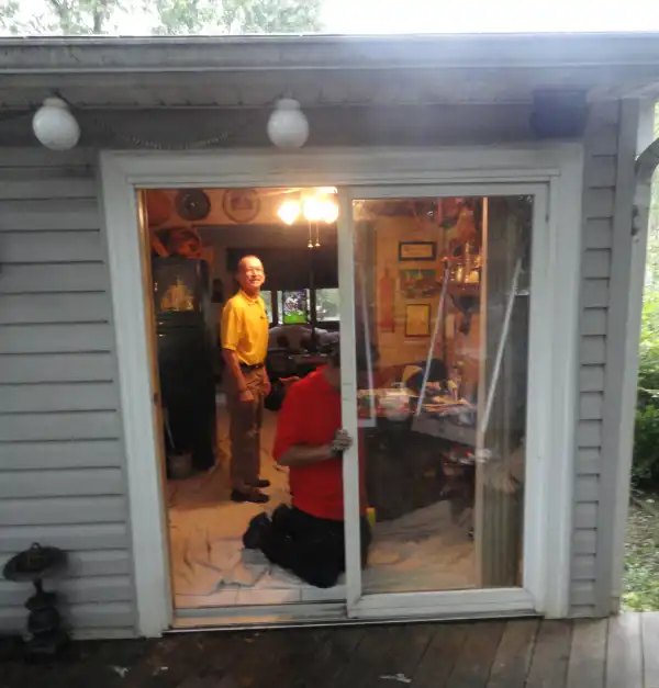 Mr. Handyman technician replacing sliding glass back door.