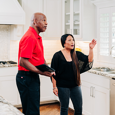 Customer with Mr. Handyman representative in kitchen.