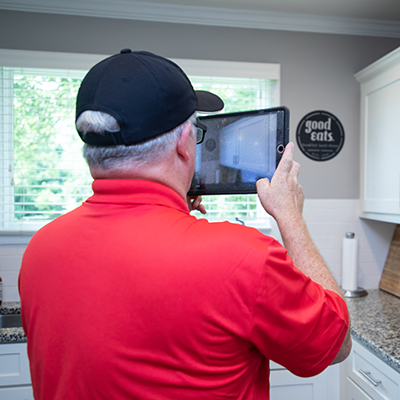 Mr. Handyman using tablet.