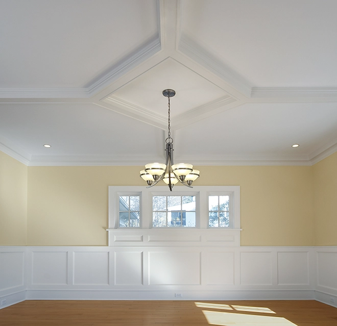Room with chandelier and wainscoting.