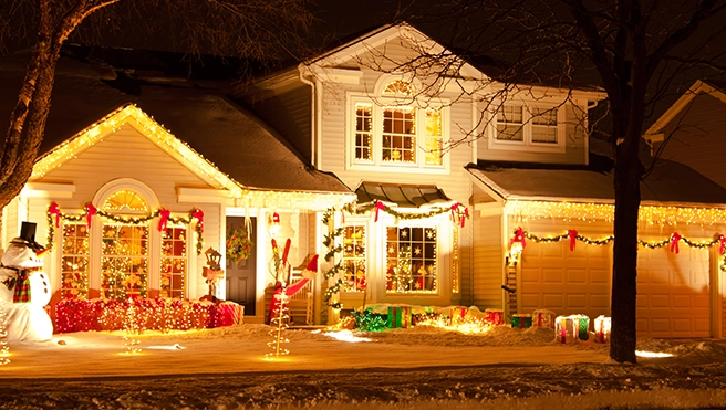 Christmas lights and decorations on home exterior.