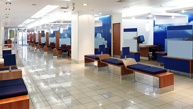 Bank reception area with chairs and computers.