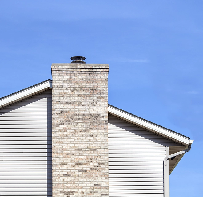 Brick chimney on side of house.