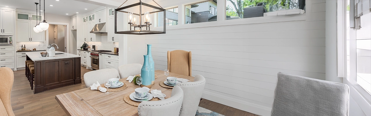 Modern dining area featuring a wooden table set with natural light.