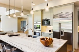 Modern kitchen featuring island and stainless steel appliances.