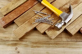 Wood decking planks with hammer and nails.