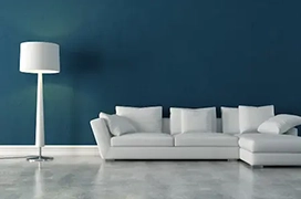 Dark green wall behind white sofa.