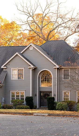 Front view of a two-story home during autumn.
