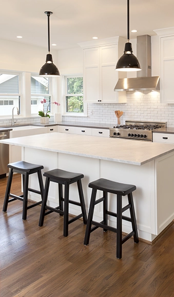 Modern white kitchen with wood floors.