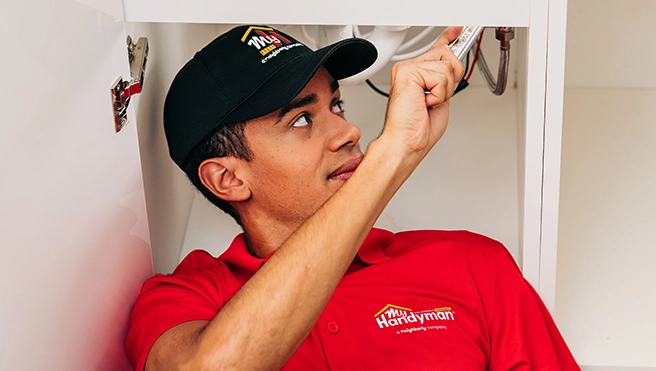 My Handyman worker repairing washbasin pipes.