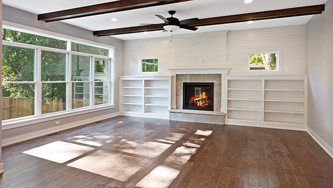 Empty room with wall shelves and a window.