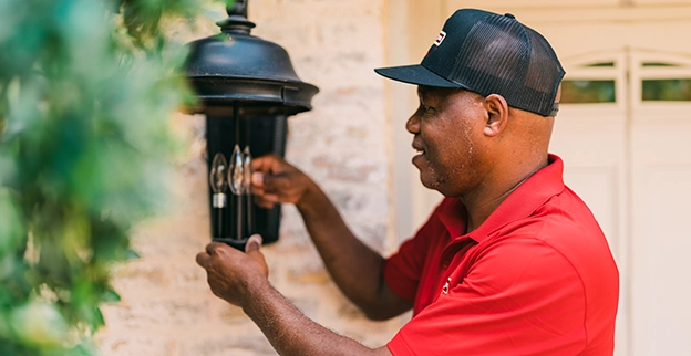 MRH employee repairing light.