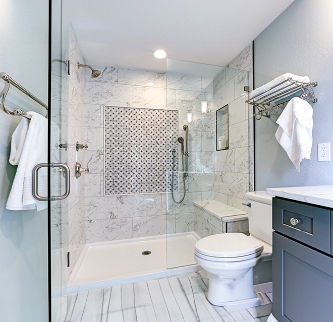 Washroom with glass shower enclosure.