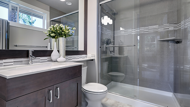 Bathroom with wood cabinet and marble trim.