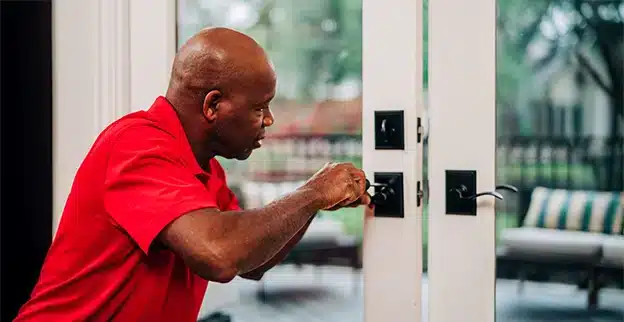 Mr. Handyman professional repairing door.