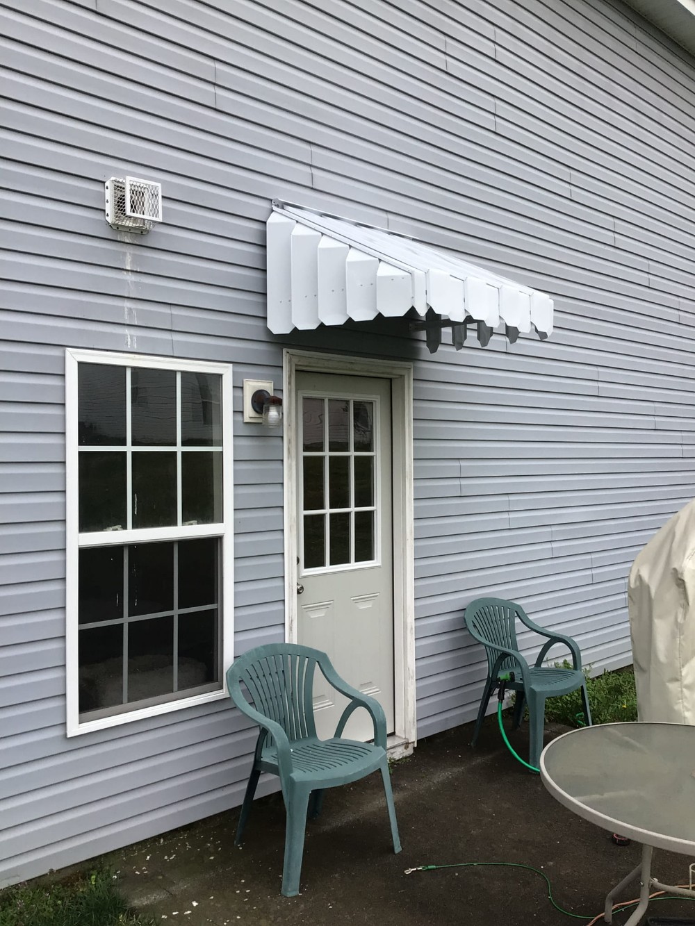 A canopy installed over a door.