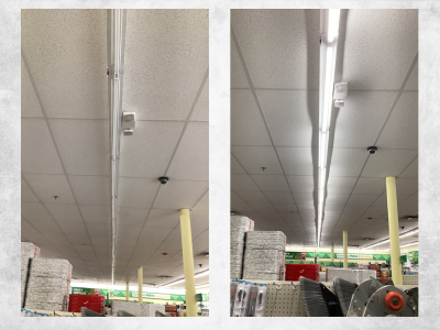 Fluorescent light fixtures installed on a suspended ceiling in a commercial space.