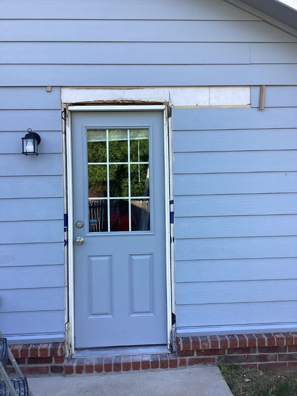 Damaged Door Frame and Siding in Broken Arrow