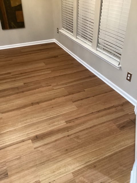 Living room with newly installed wood flooring by Mr. Handyman of South Charlotte