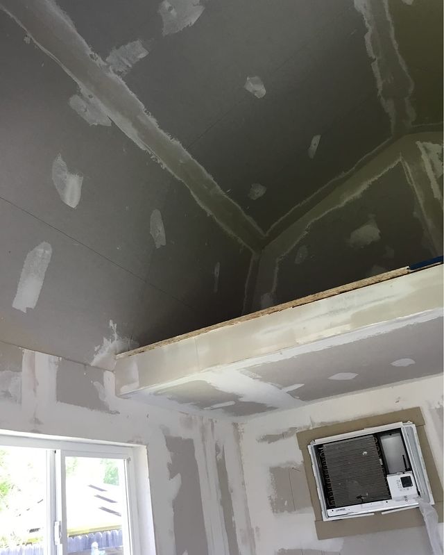 Finished shed interior with new insulation and drywall, professionally taped and bedded for a smooth, clean appearance in Arlington, Texas.