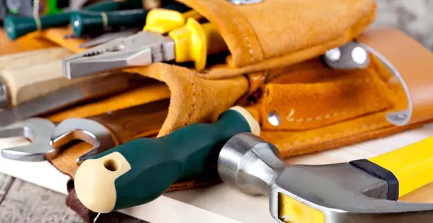 A tool belt with several tools that would be used by a handyman in Derby, KS while performing home repairs or commercial property repairs.