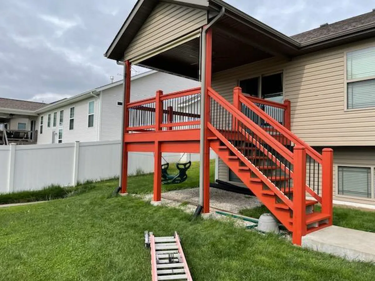 An elevated deck that has recently been refinished by a Granite City handyman.