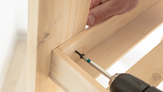 Installing wooden frames on a wall.