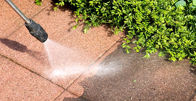 Pressure cleaning a stone slab.