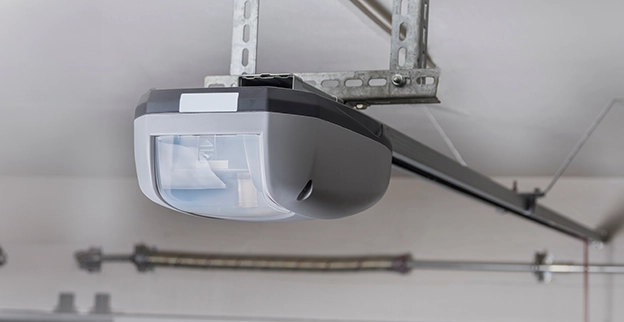 A modern, sleek gray garage door opener mounted on the ceiling.