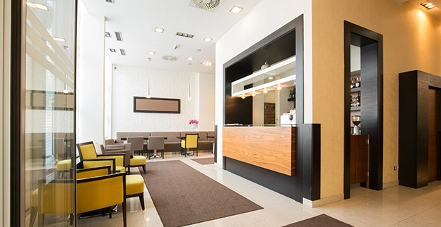 Modern reception area with a sleek wooden desk.