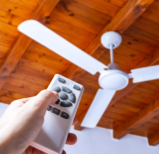 Remote controlled fan on wooden ceiling.