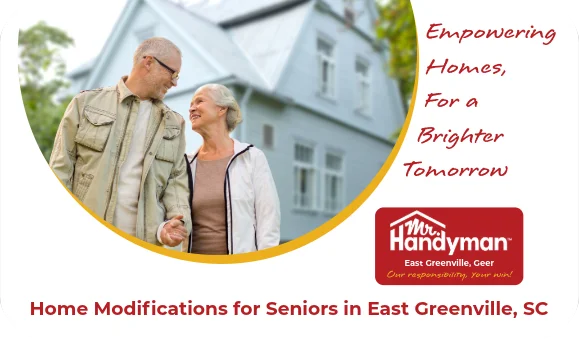 Senior man and woman smiling in front of house.