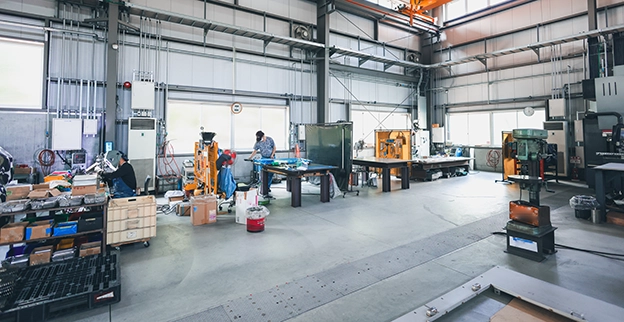 A manufacturing location with workers engaged in various tasks.