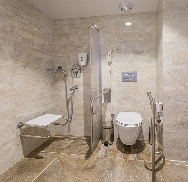 Modern accessible bathroom featuring a shower with grab bars.