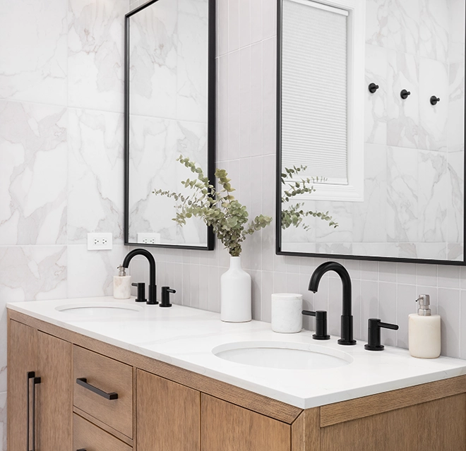 A modern bathroom featuring a double sink vanity with wooden cabinetry.