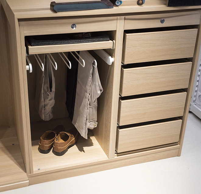 A light wood wardrobe featuring hanging space for pants