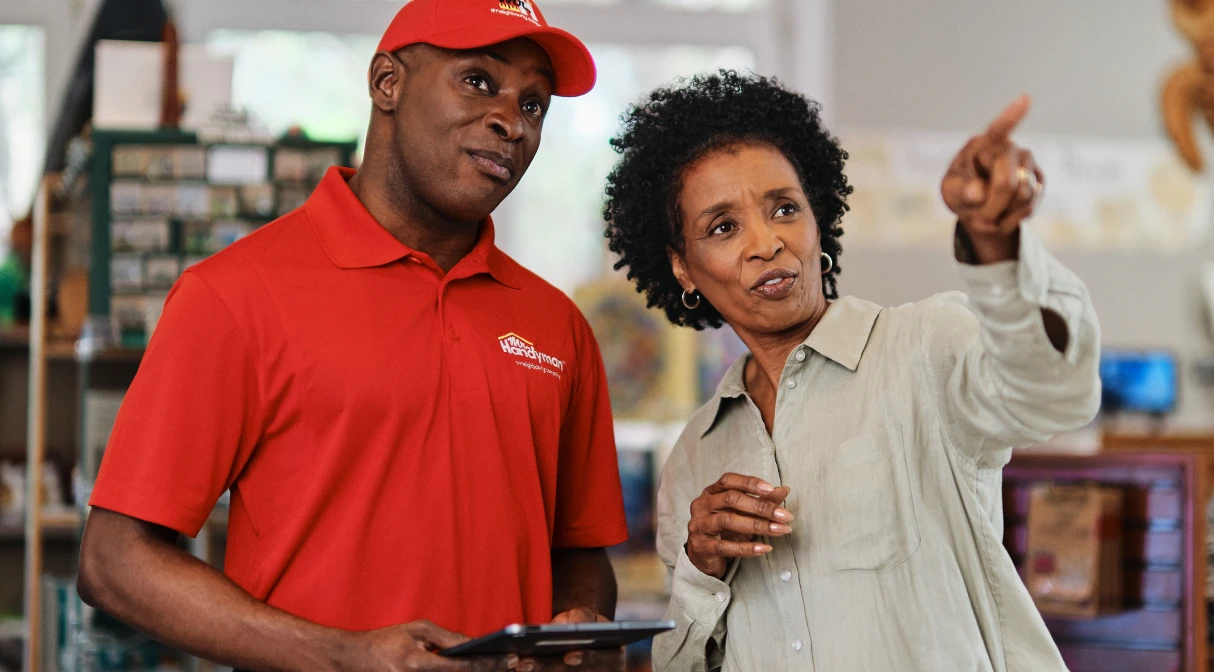 A Mr. Handyman service professional talking to a customer.