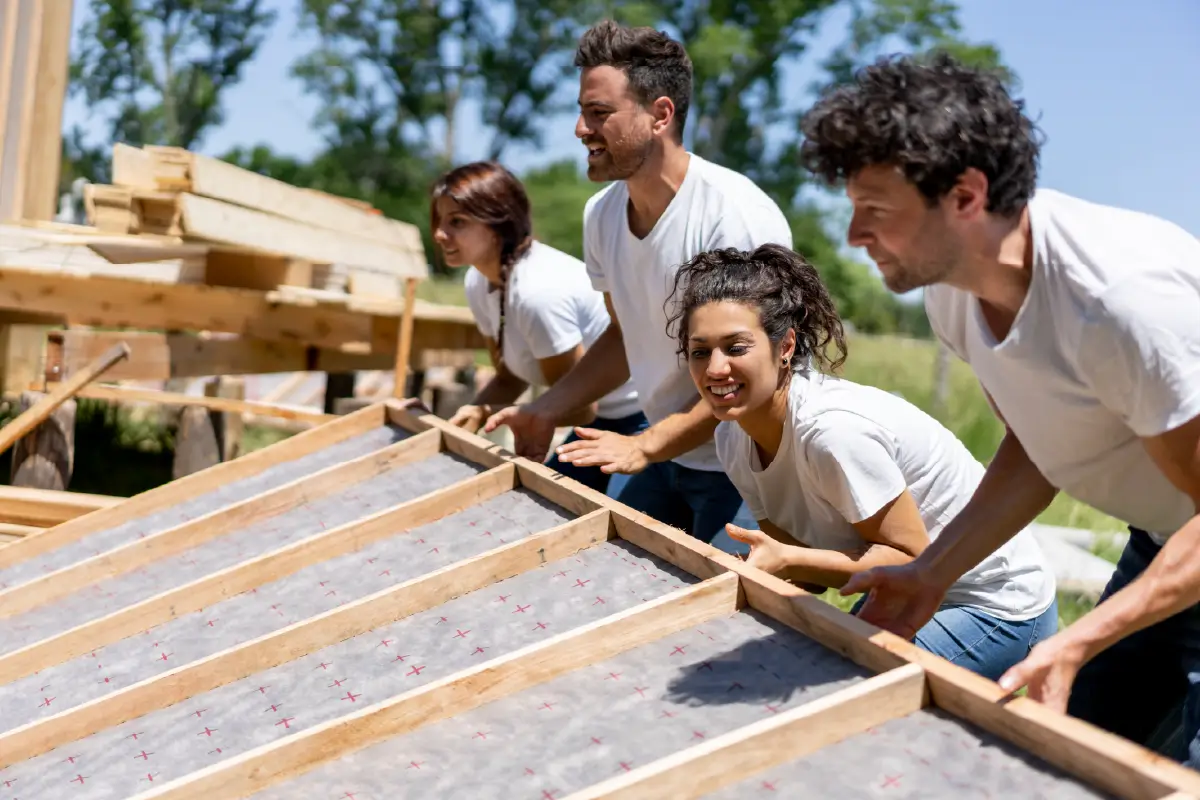 Four volunteers helping to build a home.