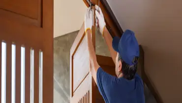A handyman fixing a sagging door