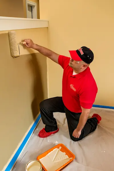 Mr. Handyman painting wall in Lehi home.