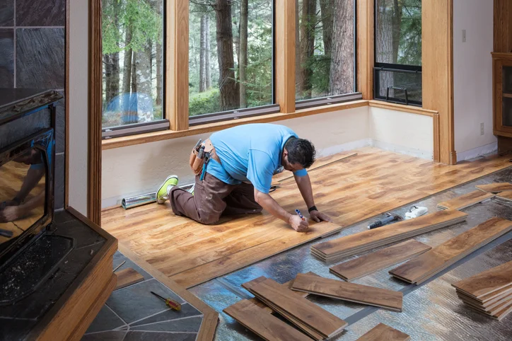 Mr. Handyman tech installing hardwood floors.