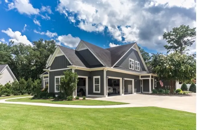 A suburban home is shown with a well-kept lawn and exterior. | Mr. Handyman of Memphis